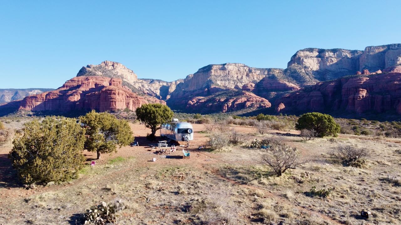 Aerial drone view of the Airstream camped in the red rocks near Sedona, Arizona